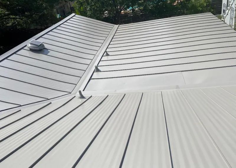 Solar attic fan installed on a metal roof for Roof Ventilation in Bronxville